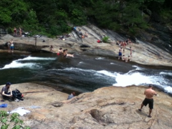 People on rocks and in waterfall.
